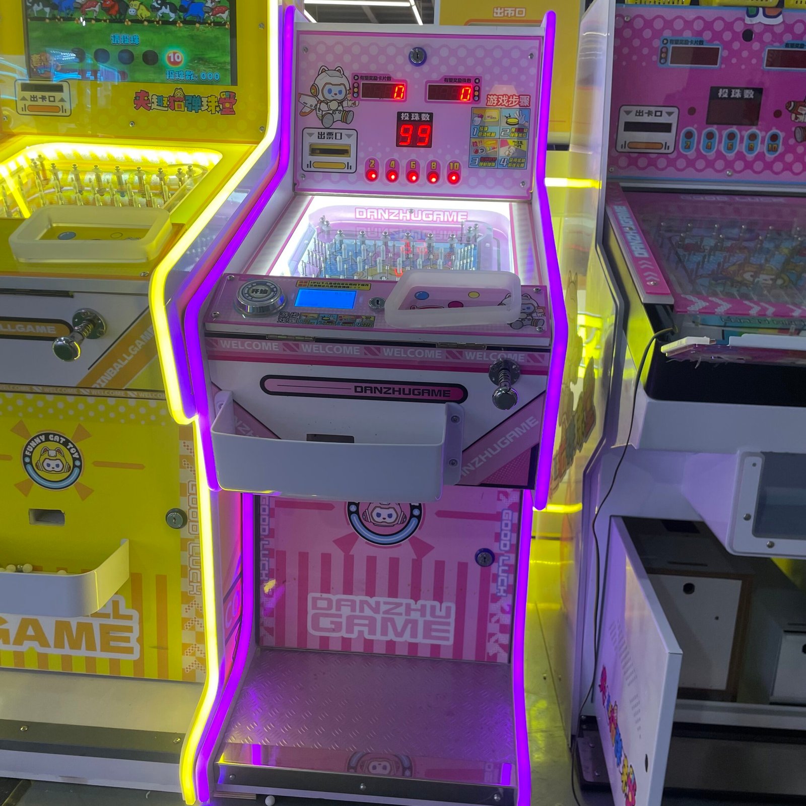 Real photo of Chengjietian arcade pinball machine installed in arcade game center with LED lighting cabinet