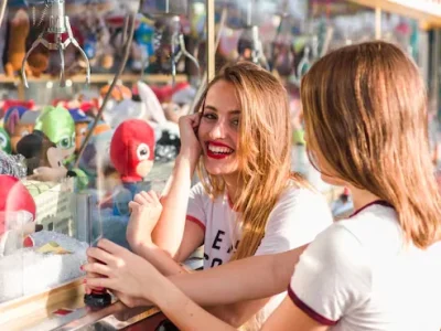 Couple browsing toy and prize stand, representing the retail and entertainment value of claw machine prizes